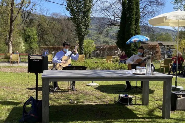 Musikstudierende Antonia Haslinger und Panagiotis Tzortzis bei ihrem Konzert für die BewohnerInnen der ÖJAB-SeniorInnenwohnanalage Aigen im Garten des Hauses.