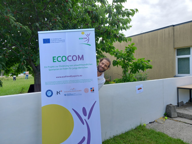 project participant with ECOCOM roll-up banner
