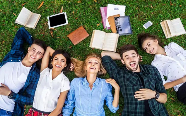 Symbolic image students lying in the grass.