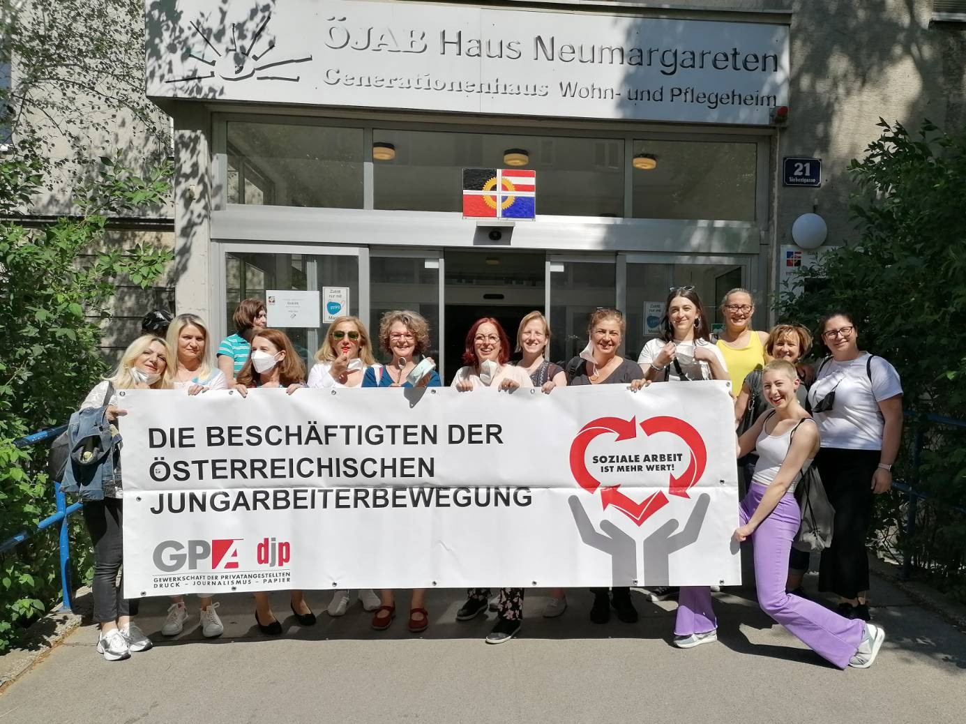 Eine Delegation von Pflegekräften der ÖJAB vor dem Eingang des ÖJAB-Hauses Neumargareten.