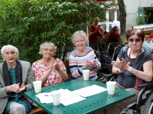 Bewohnerinnen gemeinsam am Tisch beim Grillheuriger 2021.