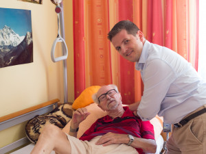 Caregiver helps clients out of bed.